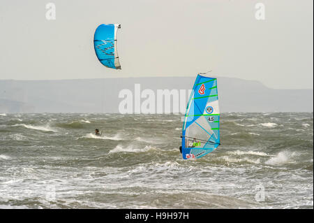 Weymouth, Dorset, UK.  24th November 2016.  UK Weather.  A windsurfer and kitesurfer taking advantage of the strong winds and choppy seas off Weymouth Beach in Dorset.  Photo by Graham Hunt/Alamy Live News Stock Photo