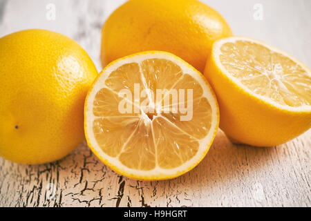 Closeup of lemons on white rustic wooden background Stock Photo