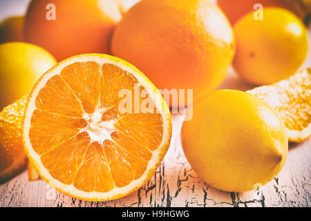 Oranges and lemons on white rustic wooden background Stock Photo