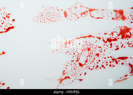 Blood drips on white surface, abstract background for violence, murder or crime scene