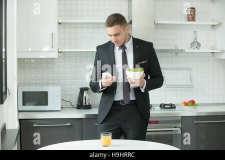 Young handsome businessman having lunch Stock Photo