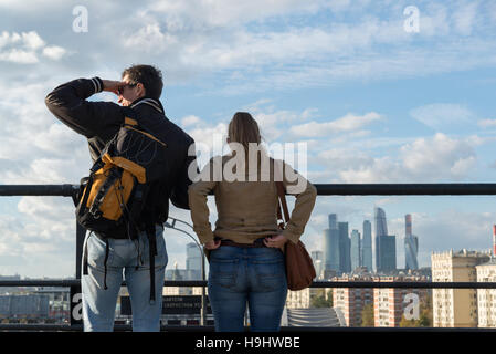 Moscow, Russia-October 01.2016. Man and woman on viewing platform looking at Moscow City Stock Photo