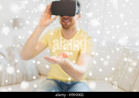 young man in virtual reality headset or 3d glasses Stock Photo
