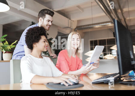 happy creative team with computer in office Stock Photo