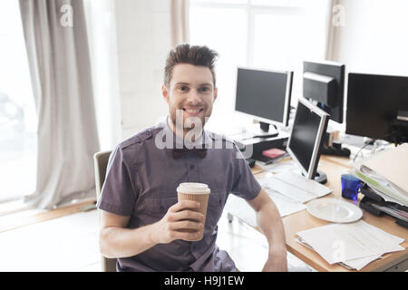 happy creative male office worker drinking coffee Stock Photo