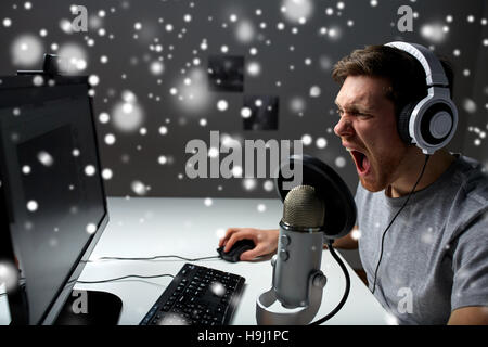 man in headset playing computer video game at home Stock Photo