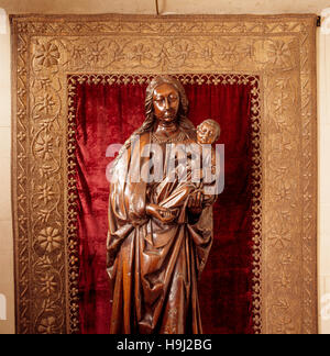 In the Long Gallery, nearly life-size carved wood figure of the Virgin and Child in frame, in the alcove. It was carved in Northern Europe in the earl Stock Photo