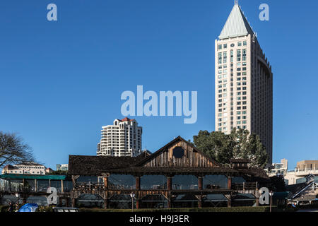 historic harbor house restaurant on san diego bay with hotels in distance Stock Photo