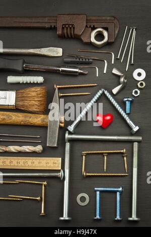Plans to build a house. Rustic wooden background. Tools for builders. Architect designing a house for a young family. Stock Photo