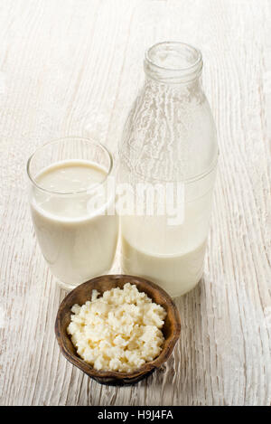 Milk kefir and grains in glass on wooden table Stock Photo