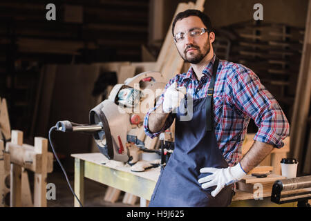 portrait of smiling construction worker pointing with finger at camera Stock Photo