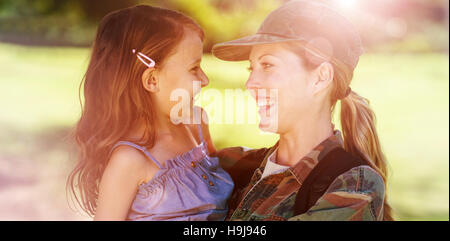 A soldier mother hugging her daughter Stock Photo