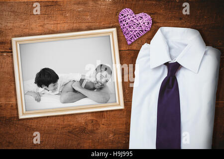 Composite image of father and his son having fun on a bed Stock Photo