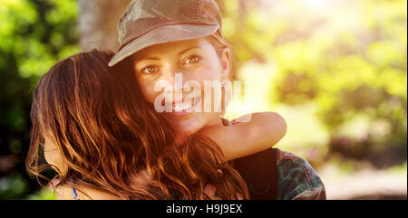 A soldier mother hugging her daughter Stock Photo