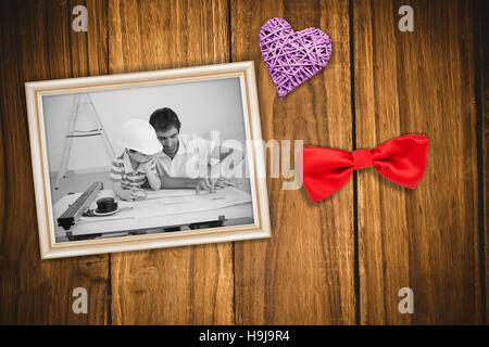 Composite image of father and son studying working with plans Stock Photo