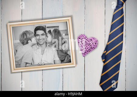 Composite image of children kissing on fathers cheeks Stock Photo