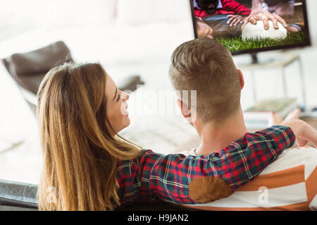 Composite image of cute couple relaxing on couch Stock Photo