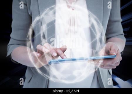 Composite image of close up of woman using tablet Stock Photo