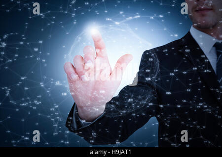Composite image of focused businessman pointing with his finger Stock Photo