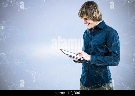 Composite image of hipster businessman using tablet Stock Photo
