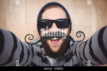 Composite image of portrait of happy hipster wearing sunglasses Stock Photo