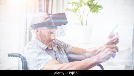 Senior man in a wheelchair using a virtual reality device Stock Photo