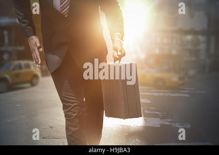 Composite image of businessman in hurry Stock Photo