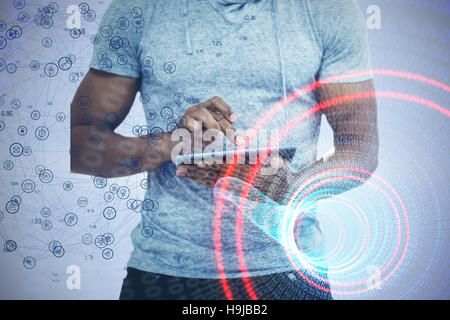 Composite image of mid section of man using tablet Stock Photo