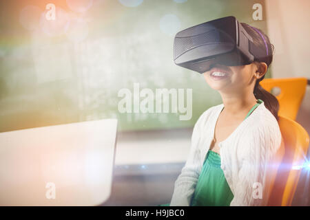 Seated girl wearing virtual reality glasses Stock Photo