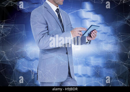 Composite image of businessman using tablet pc Stock Photo
