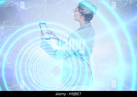 Composite image of businesswoman using a tablet Stock Photo