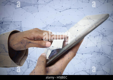 Composite image of female hands holding tablet pc Stock Photo