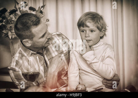 Father with his son sitting on lap Stock Photo