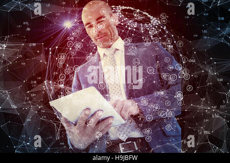 Composite image of businessman using a tablet Stock Photo