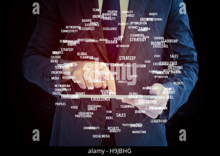 Composite image of businessman using his tablet pc Stock Photo