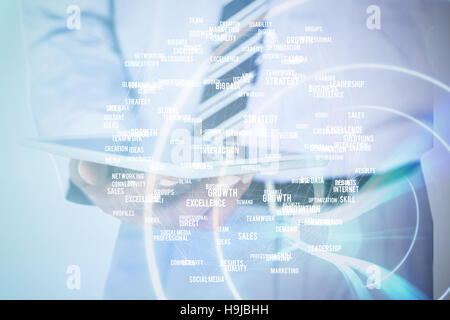 Composite image of  close up view of businessman using tablet computer Stock Photo