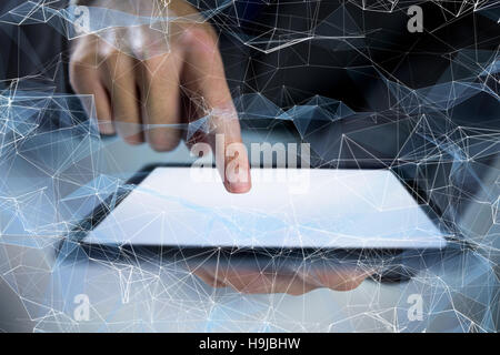 Composite image of businessman using digital tablet Stock Photo