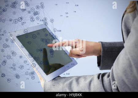 Composite image of businesswoman using a tablet pc Stock Photo