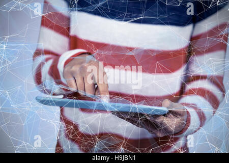 Composite image of mid section of woman using tablet Stock Photo