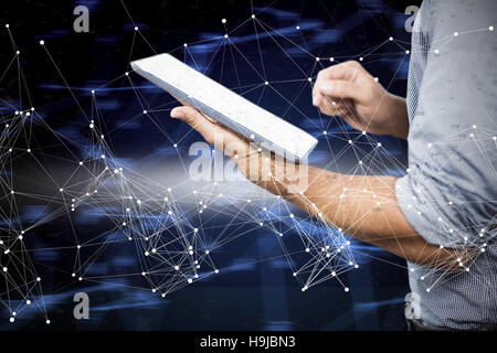 Composite image of businessman using digital tablet over white background Stock Photo