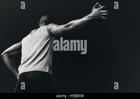 Composite image of low angle view of sportsman is practising discus throw Stock Photo