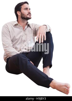 relaxed man sitting on the floor on white background Stock Photo - Alamy