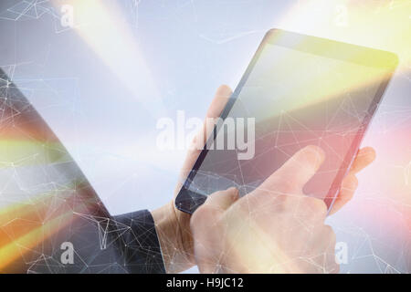Composite image of businessman using digital tablet over white background Stock Photo
