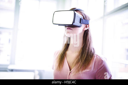 Graphic designer using virtual reality headset in office Stock Photo