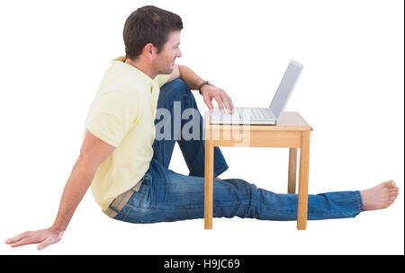 Smiling man using a laptop Stock Photo
