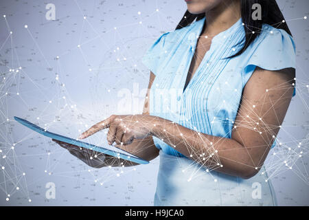 Composite image of cropped image of businesswoman using tablet Stock Photo