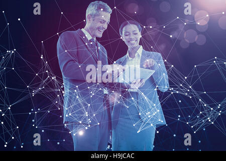 Composite image of business people using tablet computer Stock Photo