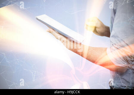 Composite image of businessman using digital tablet over white background Stock Photo