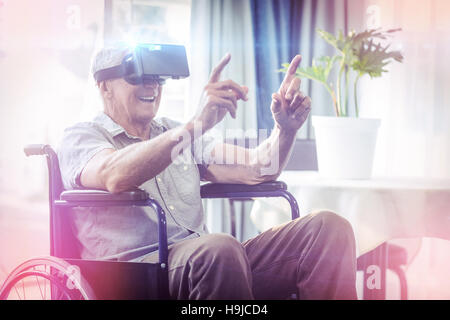 Happy senior man on wheelchair using VR headset Stock Photo