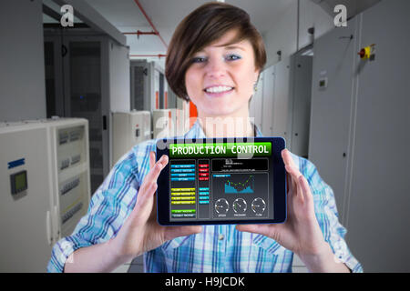 Composite image of smiling woman showing digital tablet with blank screen Stock Photo